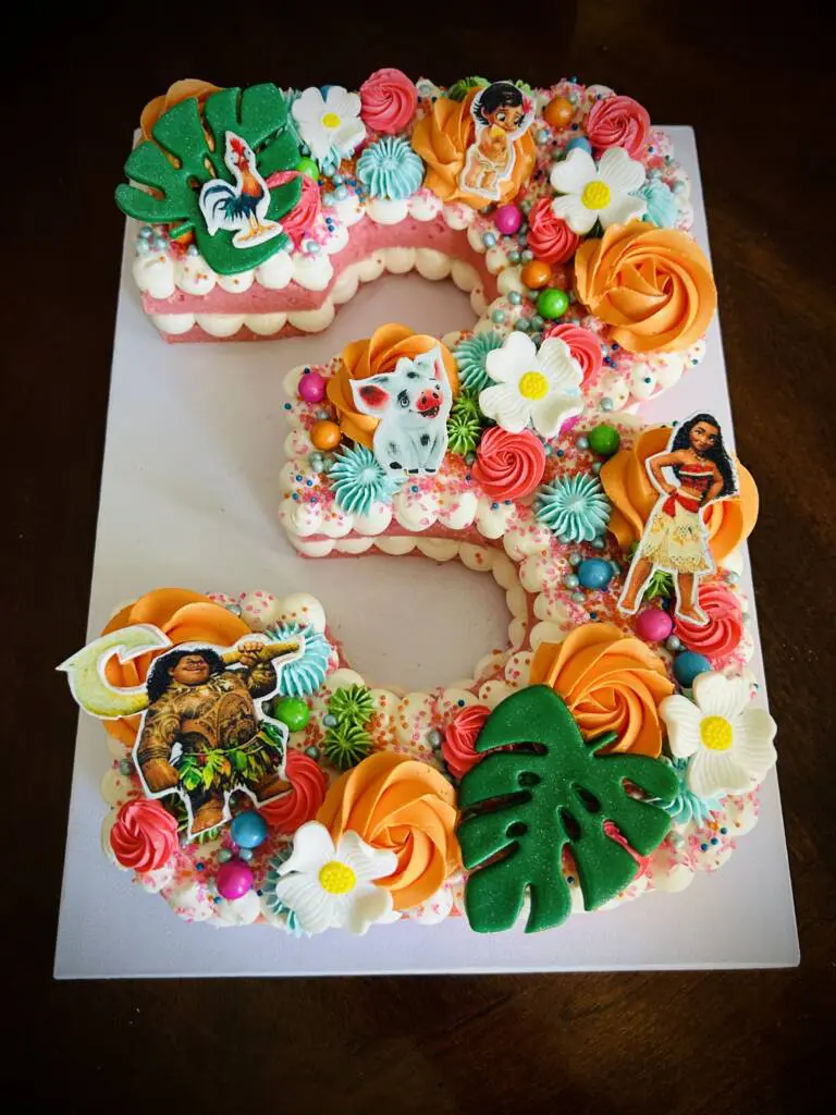 A Moana themed cake in the shape of the number 3