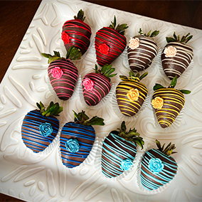 A close-up of chocolate-covered strawberries, drizzled with white chocolate, arranged on a white plate