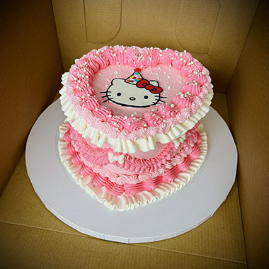 A pink and white Hello Kitty cake
